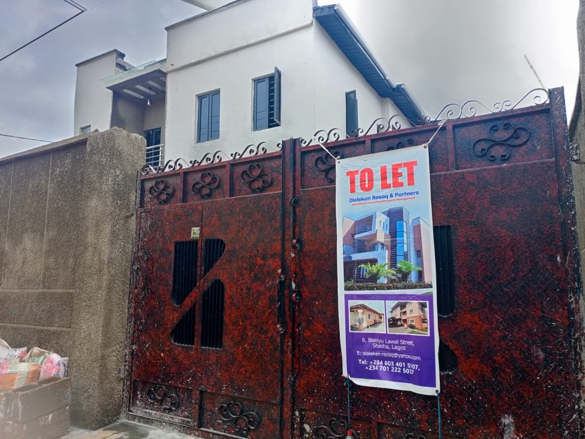 Alagbole property behind gate with Olalekan Razaq and Partners TO LET banner